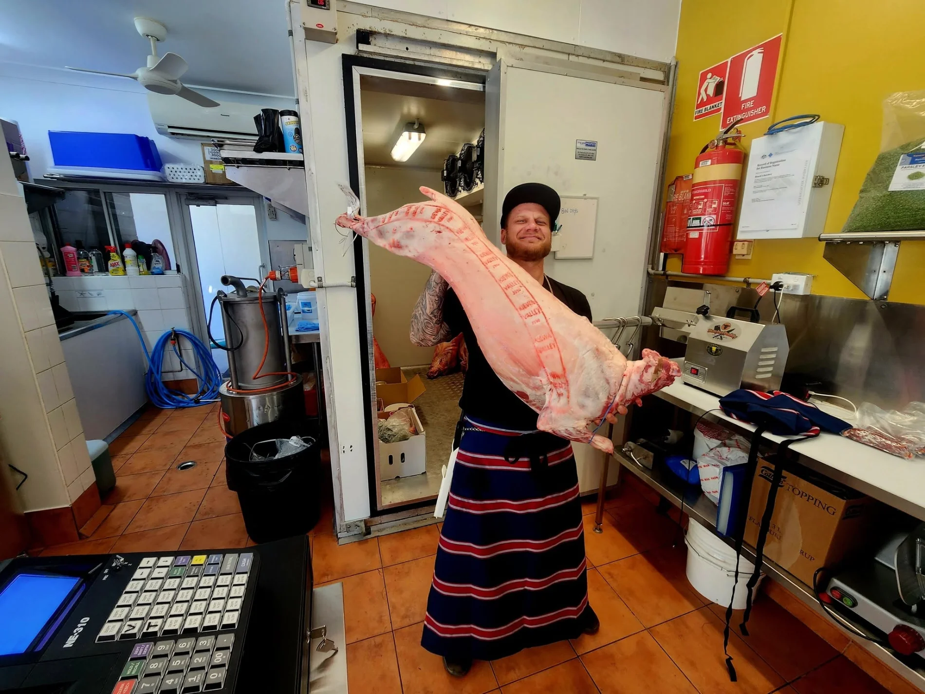 Bianchi's butcher holding pork at the Cooktown shop